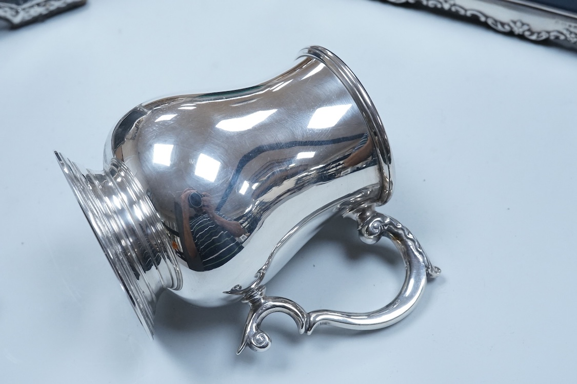 An Elizabeth II silver baluster christening mug, Wakely & Wheeler, London, 1965, with engraved inscription to the base, 10cm, together with two modern silver mounted photograph frames including a double and one other met